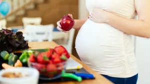 Pregnant woman with fruits and vegetables