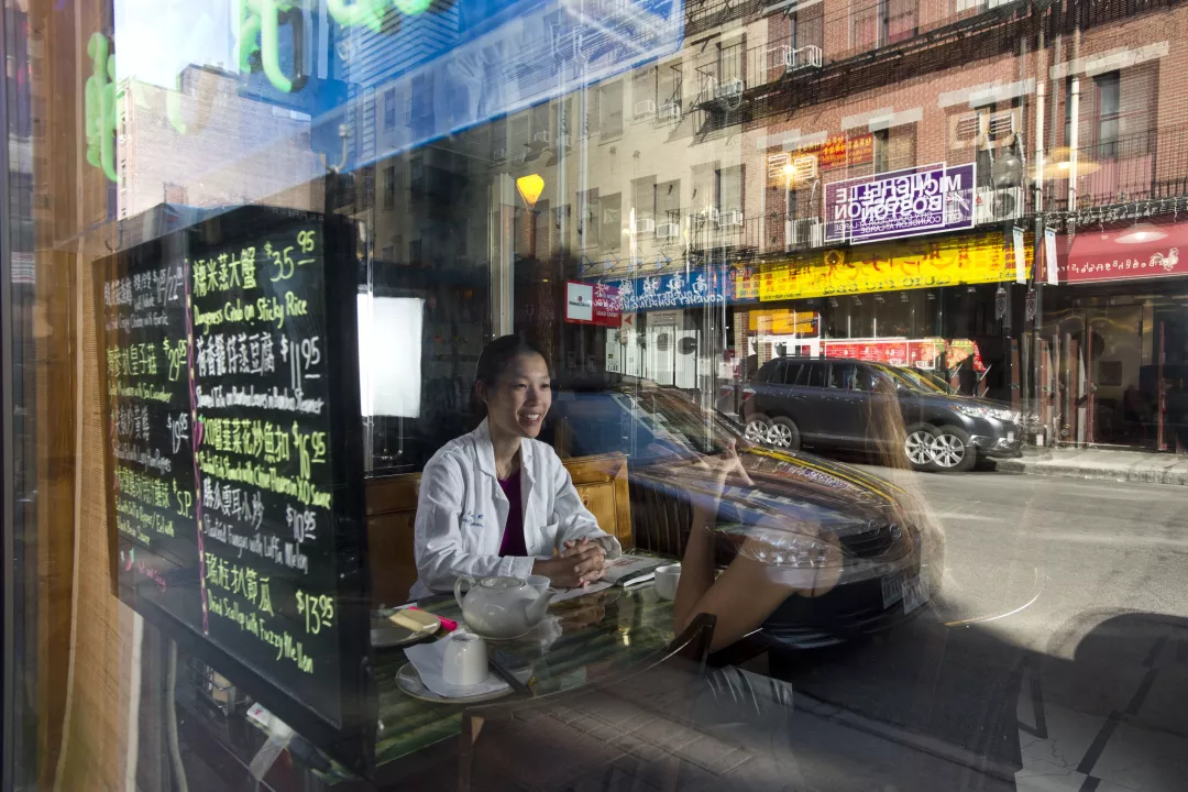 Tufts Medical Center's Jenny Ruan, MD, OBGYN doctor, sits in a cafe in Boston's Chinatown neighborhood.