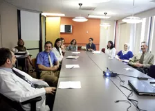 A group of clinical staff around a conference table.